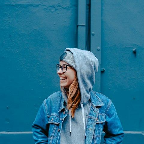 Smiling woman in glasses and a denim jacket