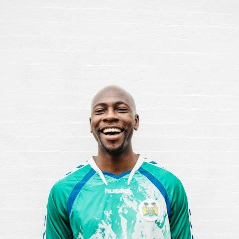 Smiling man in a green shirt
